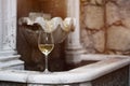 Glass of white wine on a stone fountain Royalty Free Stock Photo