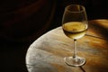 Glass of white wine swirling on table Royalty Free Stock Photo