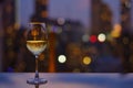 A glass of white wine on table of rooftop bar