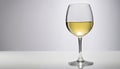 A glass of white wine on a table