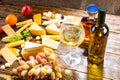 Glass of White Wine on Table with Various Cheeses Royalty Free Stock Photo