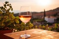 Glass of white wine on table in vineyard in Tuscany, Italy, A chilled glass of rosÃÂ© wine against a backdrop of vineyards, AI Royalty Free Stock Photo