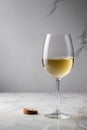 Glass of white wine on white marble table Royalty Free Stock Photo