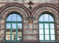 Glass window in the facade of an old house.