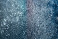 On glass window frost abstract patterns. Shimmer in different colors. White, purple, blue, celadon, pink. Winter, cold. Strong fro Royalty Free Stock Photo