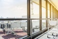 Glass window with luggage trolley at the waiting gate airport Royalty Free Stock Photo