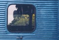 Glass window of old vintage train with blue container abstract travel background