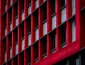 Glass window of skyscraper office building with red and white concrete wall. Exterior commercial building. Modern architecture Royalty Free Stock Photo