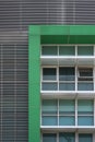 Glass windows with green frame and white fin on modern building wall decoration Royalty Free Stock Photo