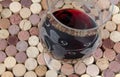 Glass of wine on a background of corks Royalty Free Stock Photo