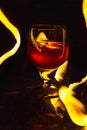 A glass of wine on a black background. Party club entertainment.