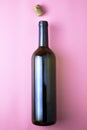 glass wine bottle and cork on pink background Royalty Free Stock Photo