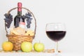 A glass of wine. A bottle of red wine, grapes and picnic basket with cheese and bread slices Royalty Free Stock Photo