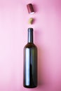 Glass wine bottle stopper and shrink cap on pink background Royalty Free Stock Photo