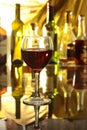 Glass of wine, brandy or cognac on the mirror wooden table Royalty Free Stock Photo