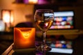 A glass of wine with a candle and laptop Royalty Free Stock Photo