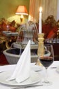 Glass with wine and candle at table