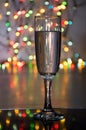 Glass of wine on garland christmas background Royalty Free Stock Photo