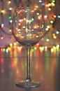 Glass of wine on garland christmas background Royalty Free Stock Photo