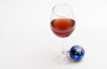 Glass with wine and christmas decoration. Winter celebration with alcohol drink. Wineglass with red liquid or wine and Royalty Free Stock Photo