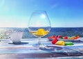 Glass of wine ,cup of coffee  and exotic fruits on wooden table  at  beach cafe sea , summer blue sky flying petal nature backgrou Royalty Free Stock Photo