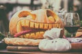 A glass of wine with decorations for Halloween on the table