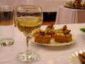 Glass glass with wine on a festive table with desserts cake