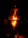 A glass of wine with fire in the background Royalty Free Stock Photo