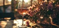 a glass of wine in front of a flower vase Royalty Free Stock Photo