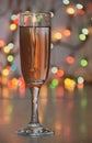 Glass of wine on garland christmas background Royalty Free Stock Photo