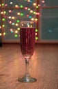 Glass of wine on garland christmas background Royalty Free Stock Photo