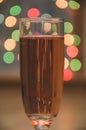 Glass of wine on garland christmas background Royalty Free Stock Photo