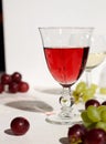 Glass of wine and grape branch isolated on white background Royalty Free Stock Photo