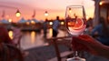 glass of wine in hand on evening pink sunset summer beach restaurant beach , romantic couple silhouette