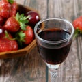 glass with wine on juicy fresh tasty strawberries Royalty Free Stock Photo