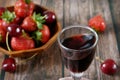 glass with wine on juicy fresh tasty strawberries Royalty Free Stock Photo