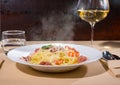 Glass with wine near spaghetti pasta with shrimps, grated cheese Royalty Free Stock Photo