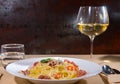 Glass with wine near tasty spaghetti pasta with shrimps, grated Royalty Free Stock Photo