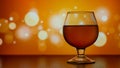 glass with a wine on the orange background with bokeh circles Royalty Free Stock Photo