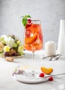 Glass of wine with peaches ice and mint Royalty Free Stock Photo