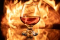 Glass of wine on table with fire in background Royalty Free Stock Photo