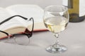 Glass of wine on a table with a open book Royalty Free Stock Photo