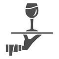 Glass of wine on tray in hand solid icon, Wine festival concept, Drinks Service sign on white background, Hand of waiter Royalty Free Stock Photo