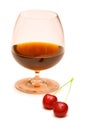 Glass of wine and two cherries Royalty Free Stock Photo