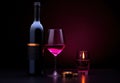glass of wine and two red wine bottles Royalty Free Stock Photo