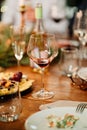 Glass of wine on a wooden table during a festive candlelit dinner. romantic date