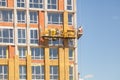 Glass wool insulation. The worker insulates the house standing on the scaffolding