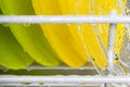 Glass yellow and green plates, background of clean kitchen utensils in the dishwasher Royalty Free Stock Photo