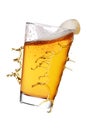 Glass of yellow splashing beer isolated on white