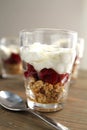 Glass with yogourt, berry coulis and nuts Royalty Free Stock Photo